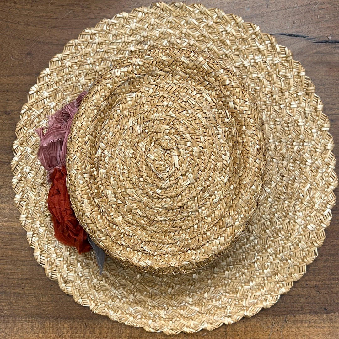 Vista dall'alto cappello di paglia da donna con fiori in seta sul lato sinistro